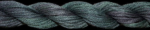 Close-up of green and blue twisted thread on a black background