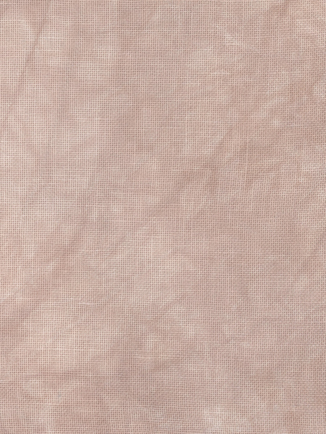 A close-up of a textured fabric with a fine woven pattern in a dusty rose or mauve pink color.