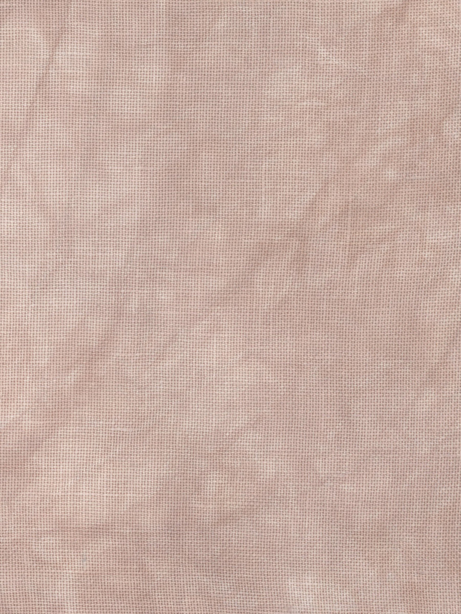 A close-up of a textured fabric with a fine woven pattern in a dusty rose or mauve pink color.
