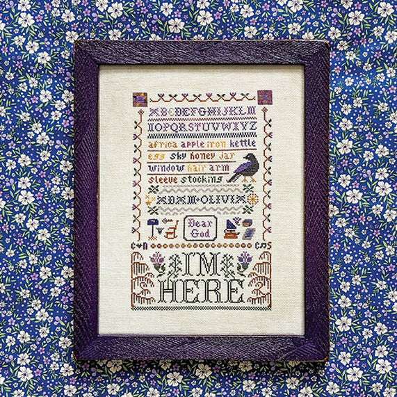 Cross stitch pattern framed on a floral background