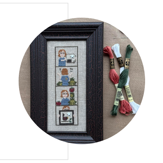 Framed cross-stitch artwork about 'A Stitcher's Life' photobooth on a white background.