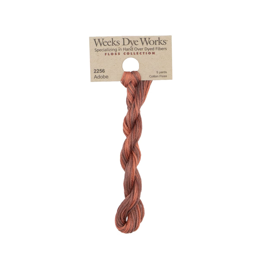 A single twisted bundle of Weeks Dye Works Floss Collection cotton thread in the shade Adaba, attached to a kraft paper header card.