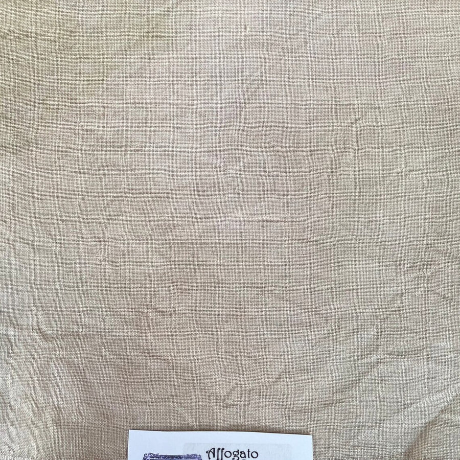 Textured beige fabric with a label in the corner