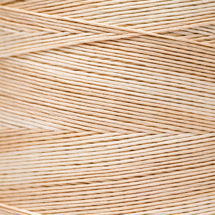 A close-up texture shot of light beige braided thread or cord, showing the fine strands woven in a diagonal pattern.