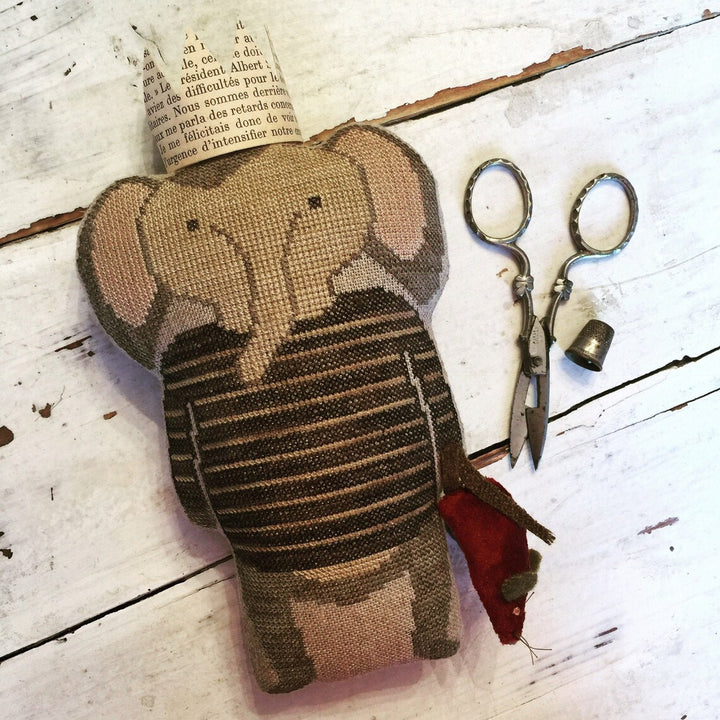 elephant wearing striped sweater holding red mouse wearing paper crown