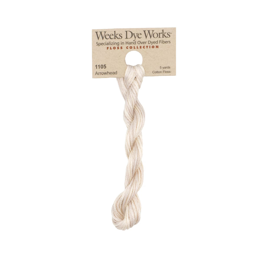 A single skein of Weeks Dye Works Arrowhead cotton flax fiber yarn, displayed vertically on its original kraft paper hanger against a solid white background.