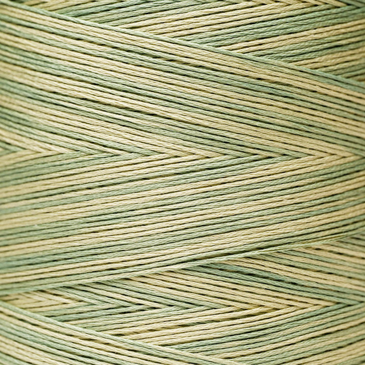 A close-up of textured yarn wound in a herringbone pattern, featuring alternating stripes of sage green and light beige.