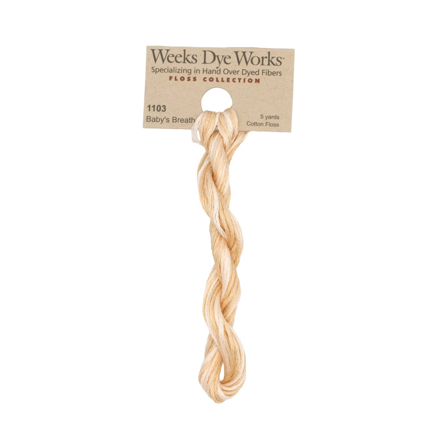 A 5-yard skein of Weeks Dye Works Baby's Breath cotton floss in a light peach-beige color, hanging from its original kraft paper packaging header card against a solid white background.
