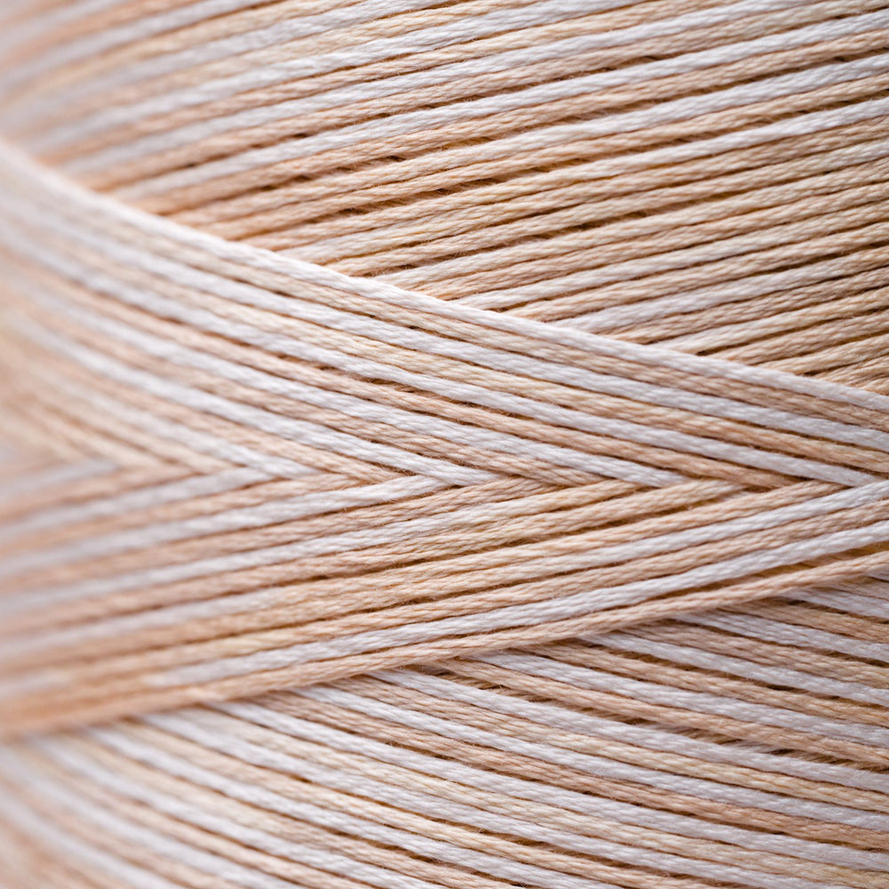 Close-up of beige and white thread strands