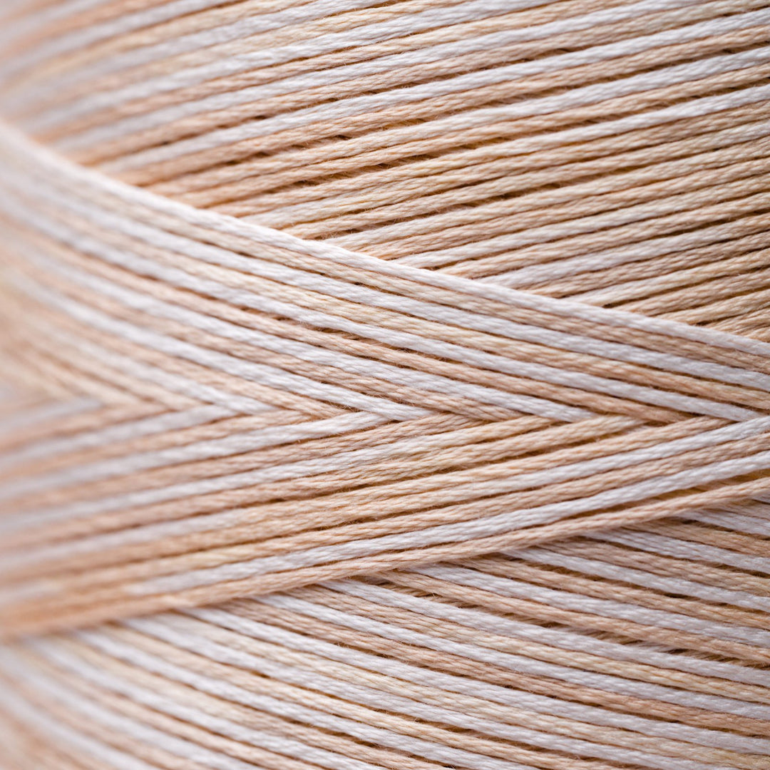 Close-up of beige and white thread strands