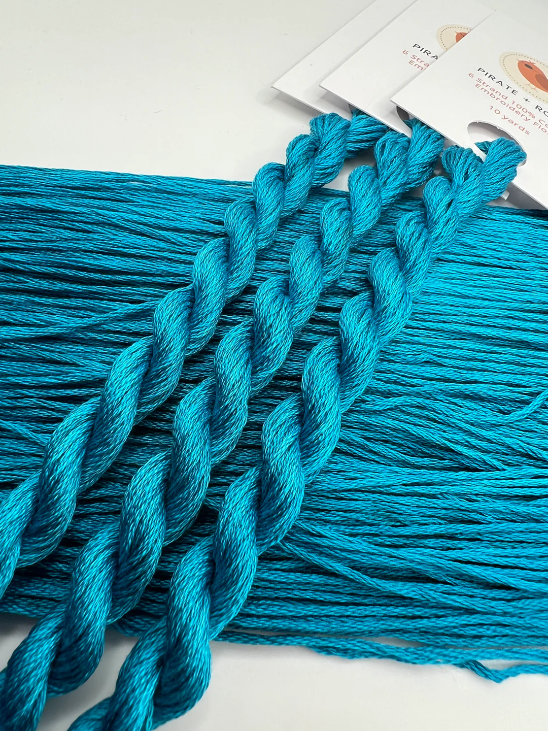 Blue embroidery floss  with a white background