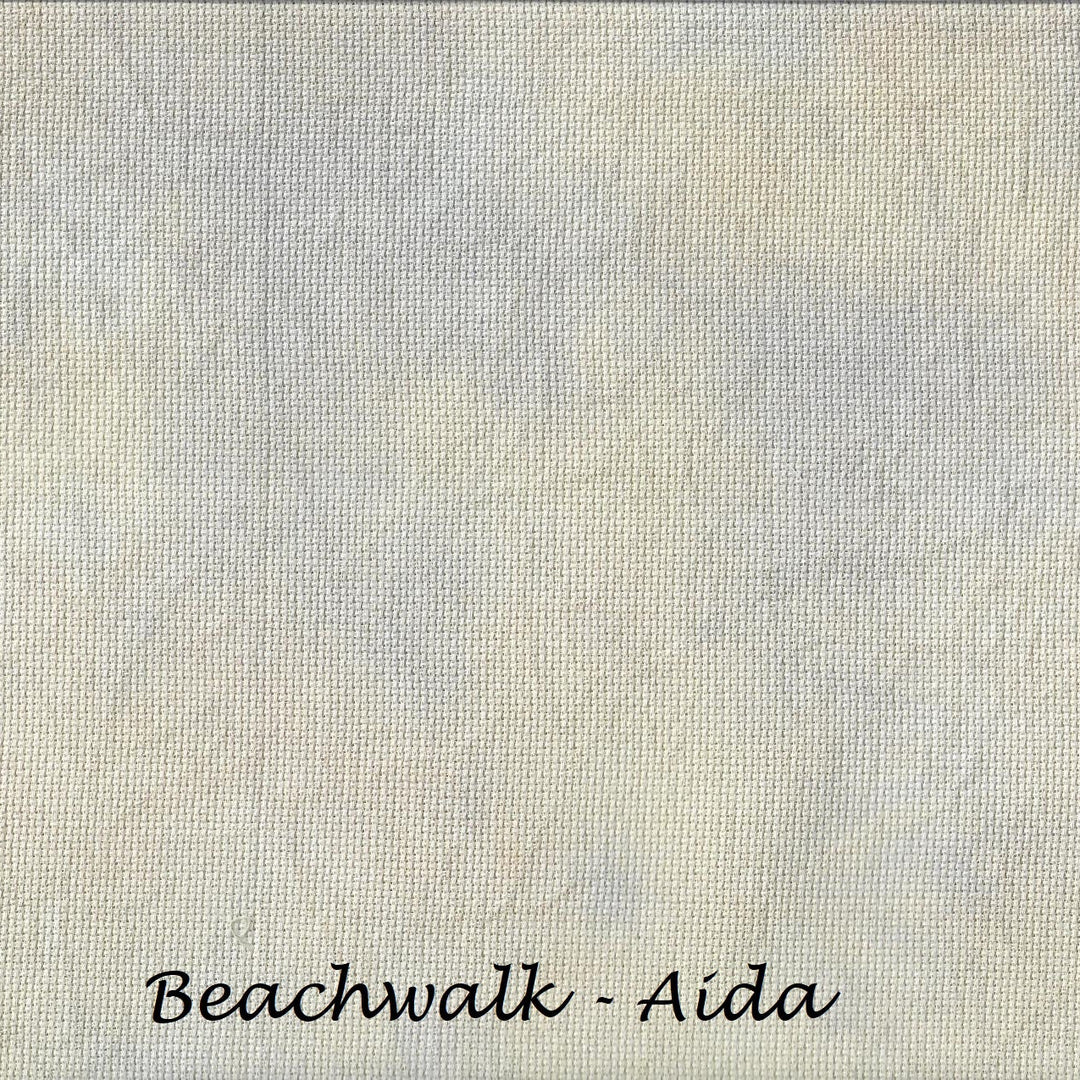 A square fabric or material swatch with a soft, textured surface in a warm off-white and light beige tone, with the text 'Beachwalk - Aida' printed in black at the bottom.