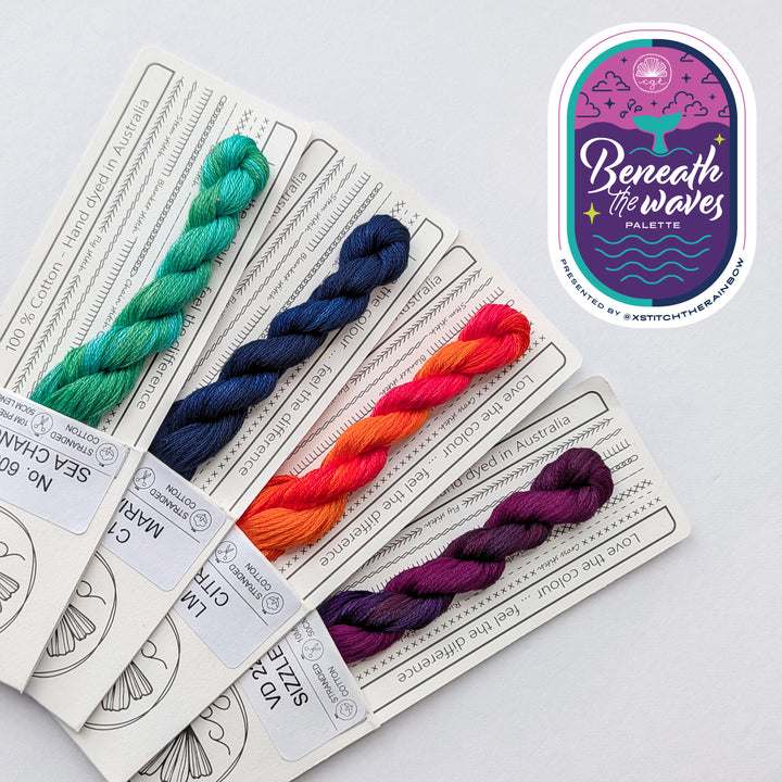 four skeins of cottage garden threads in bright teal, navy, pink/orange, and purple/pink, making up the beneath the waves palette with xstitchtherainbow
