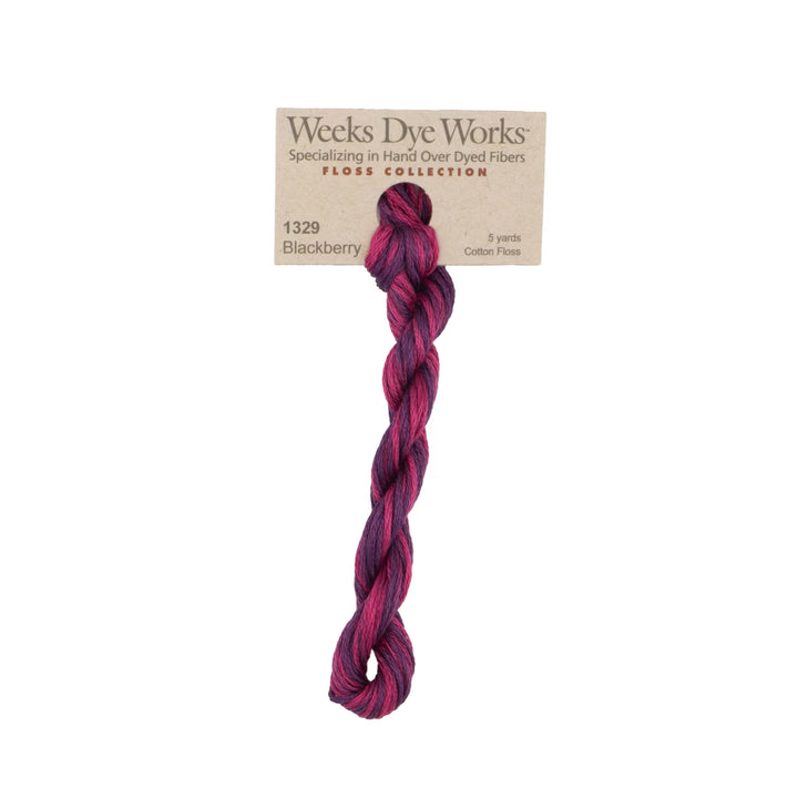 A single twisted hank of Weeks Dye Works Floss Collection cotton fiber in shade 1329 Blackberry, featuring a marbled blend of deep purple, magenta, and dark red tones, attached to its kraft paper label on a white background.