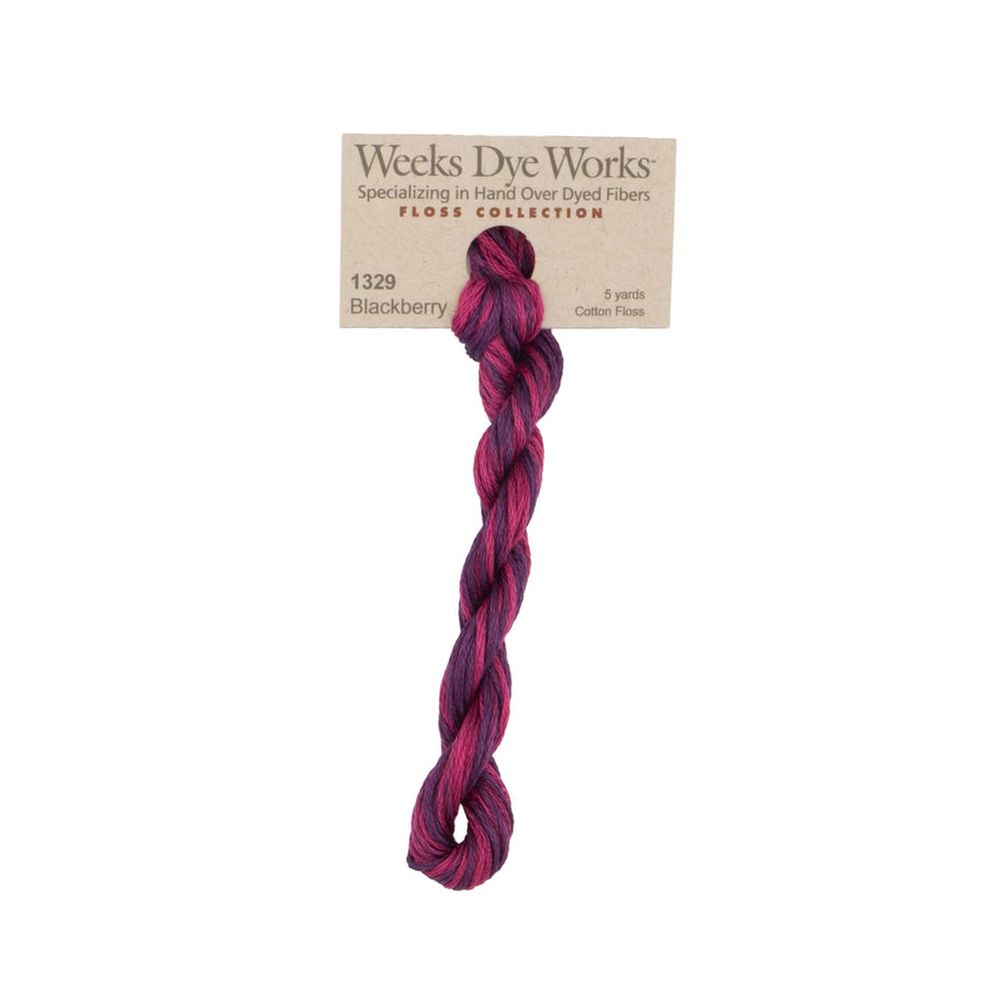 A single twisted hank of Weeks Dye Works Floss Collection cotton fiber in shade 1329 Blackberry, featuring a marbled blend of deep purple, magenta, and dark red tones, attached to its kraft paper label on a white background.