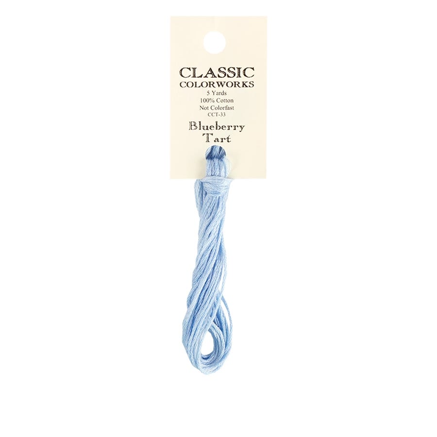 A skein of Classic Colorworks hand-dyed embroidery floss in a light blue color, labeled 'Blueberry Tart'.