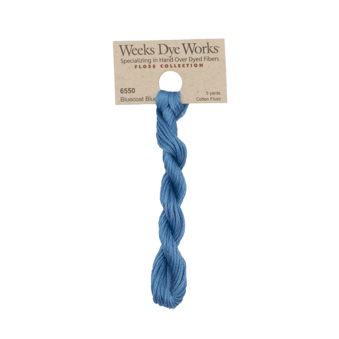 A single skein of Weeks Dye Works Floss Collection cotton thread in Bluecoat Blue, attached to a kraft paper hanger card.