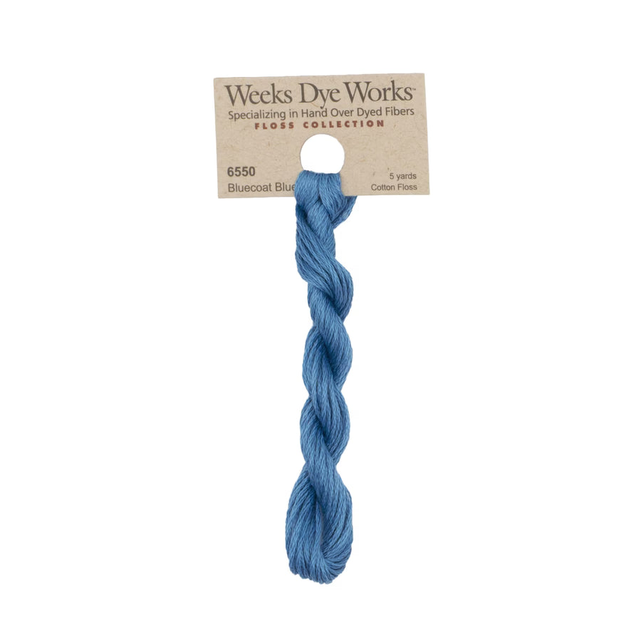 A single skein of Weeks Dye Works Floss Collection cotton thread in Bluecoat Blue, attached to a kraft paper hanger card.