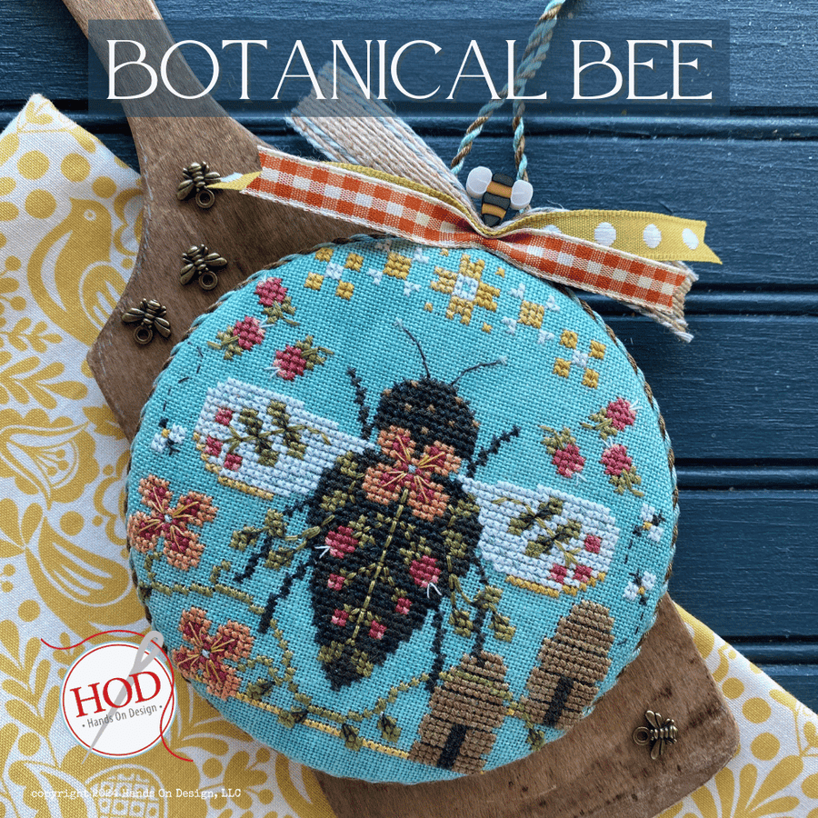 Embroidered bee design on a blue background with 'BOTANICAL BEE' text and HOD logo.