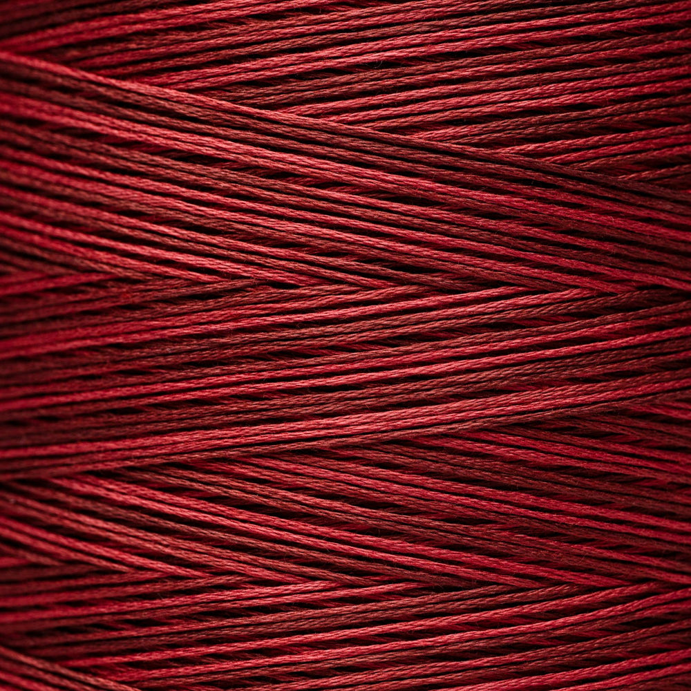 A close-up of tightly wound red thread or cord showing the texture and color of the material.