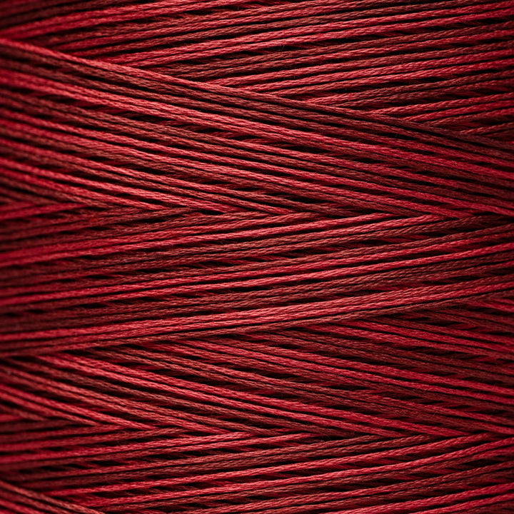 A close-up of tightly wound red thread or cord showing the texture and color of the material.