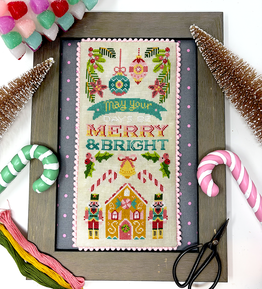 Cross-stitched Christmas design with 'Merry & Bright' text, surrounded by festive decorations.