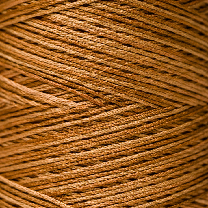 A close-up texture shot of tightly wound brown thread or cord, filling the entire frame.