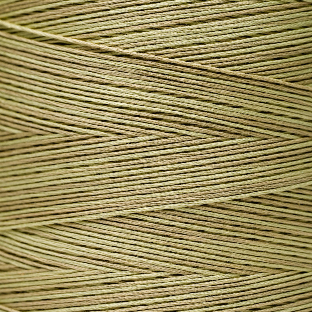 A close-up texture shot of light tan or beige braided thread wound in a herringbone pattern.