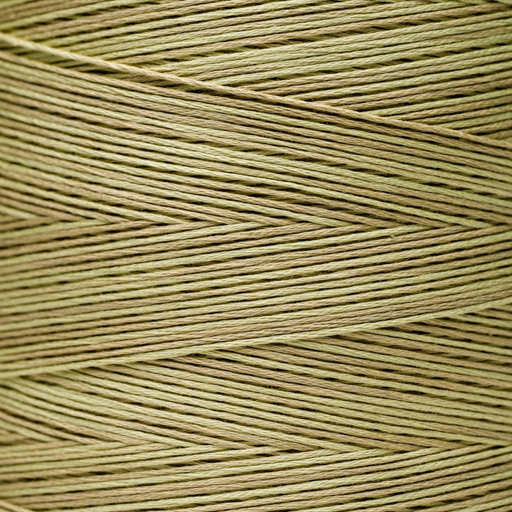 A close-up texture shot of light tan or beige braided thread wound in a herringbone pattern.