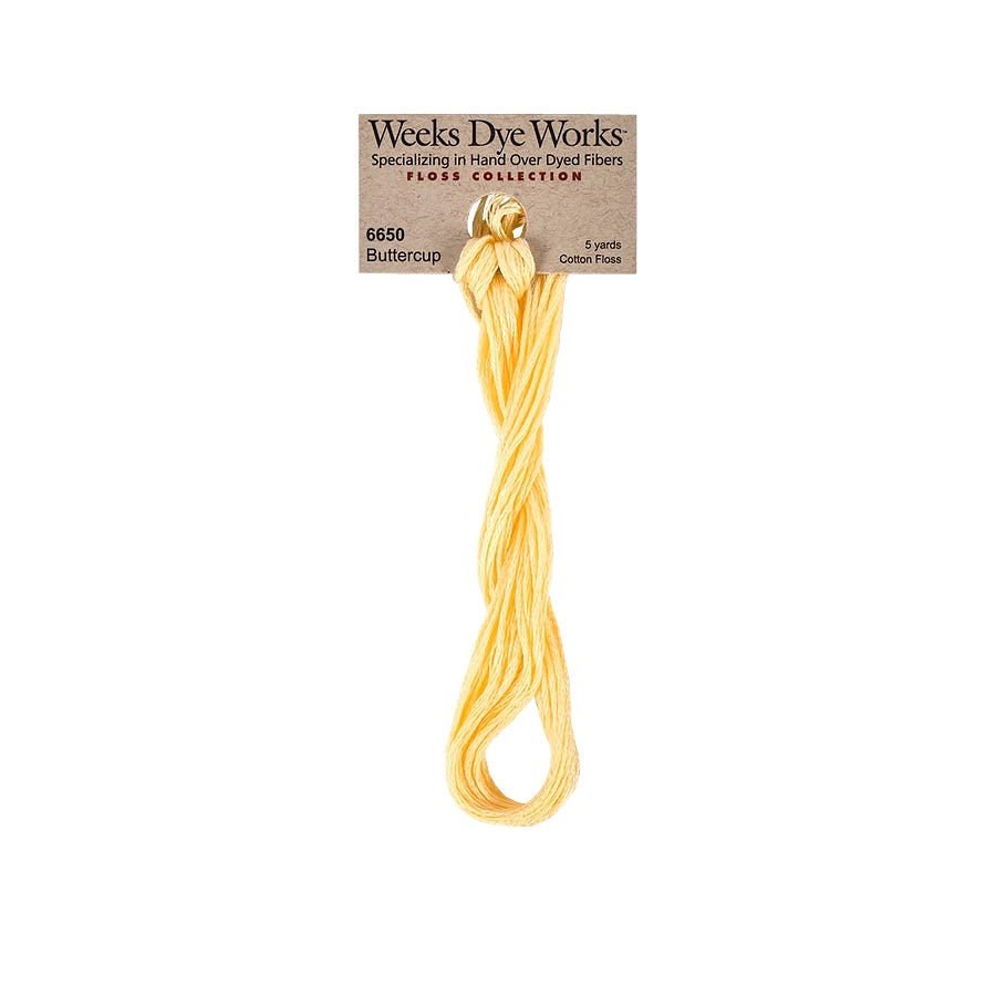 Yellow Weeks Dye Works floss on a white background