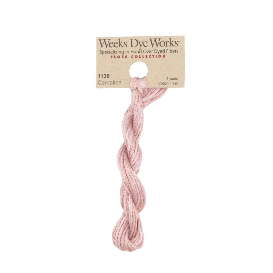A single twisted skein of Weeks Dye Works cotton floss in the shade Carnation, attached to its original kraft paper label card, shown against a plain white background.