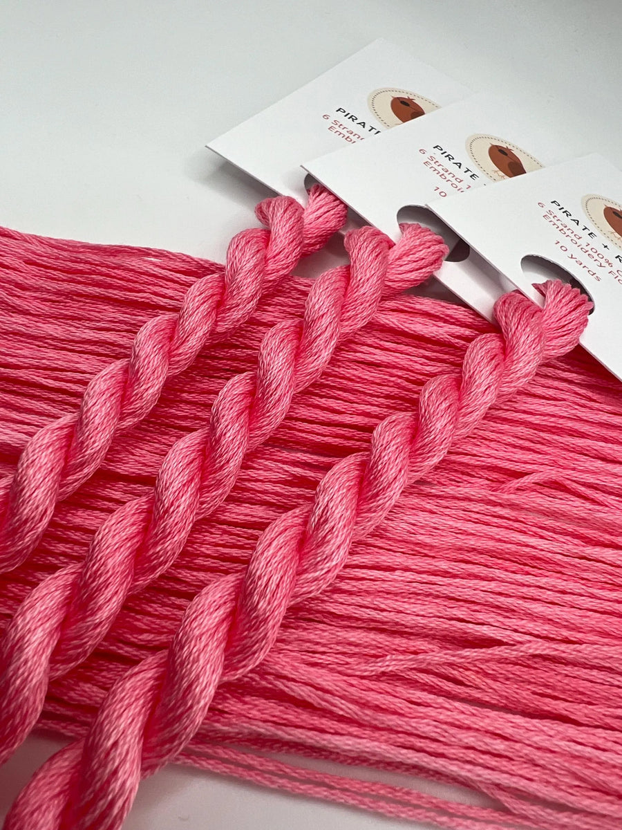 Pink embroidery floss with packaging on a white background