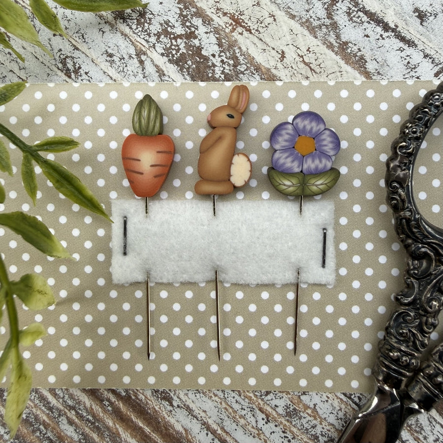 Decorative wall hook with rabbit, carrot, and flower design on a polka dot background.