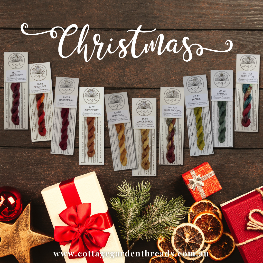 Collection of yarn samples with Christmas decorations on a wooden background