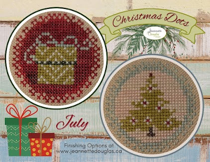 Cross-stitched Christmas designs with 'Christmas Dots' branding on a wooden surface.