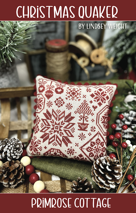 Decorative pillow with Christmas pattern on a wooden surface with festive decorations.