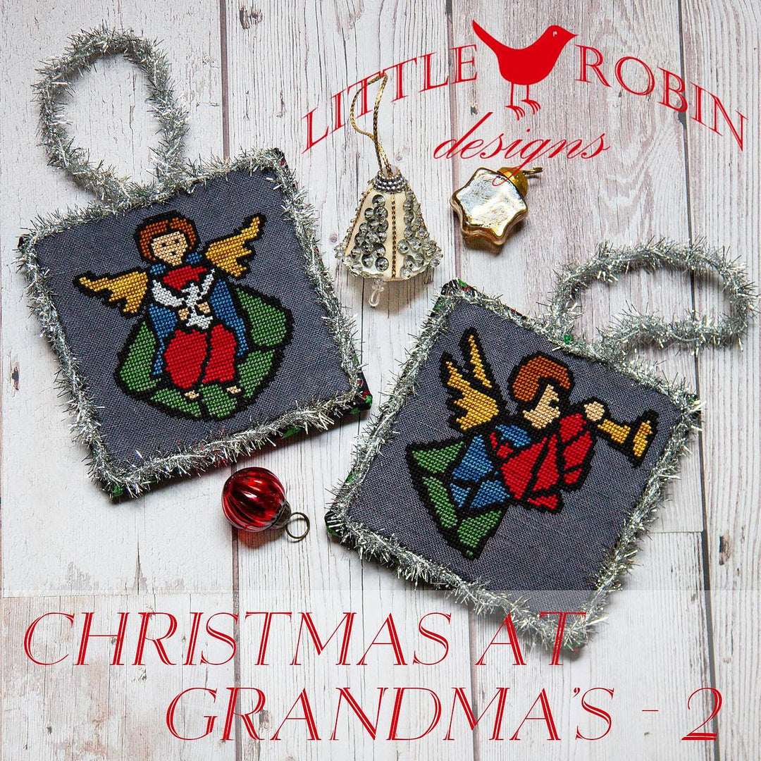 Cross stitch kits depicting angels and Christmas trees with 'Little Robin Designs' branding, and text 'Christmas at Grandma's 2'.