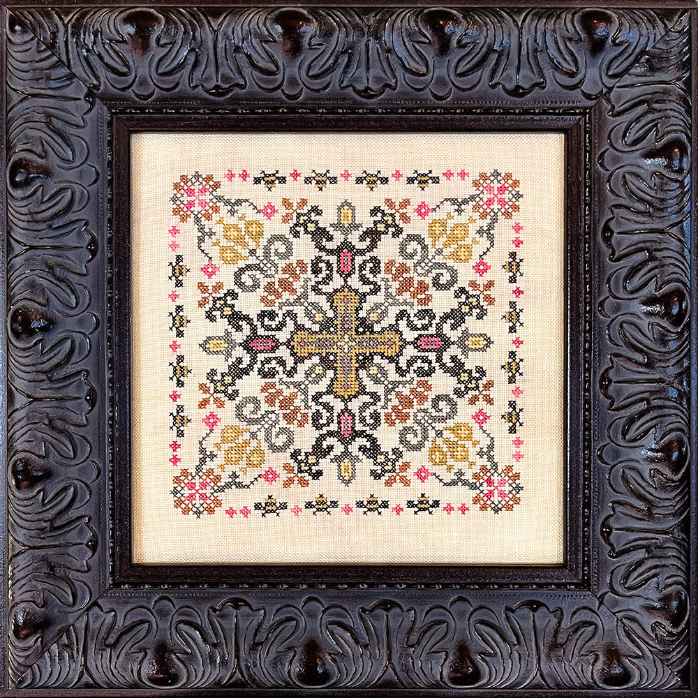 Decorative cross-stitched pattern in a ornate black frame