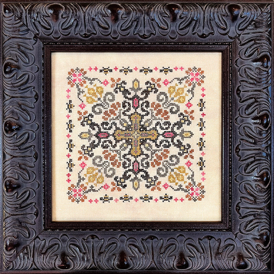 Decorative cross-stitched pattern in a ornate black frame