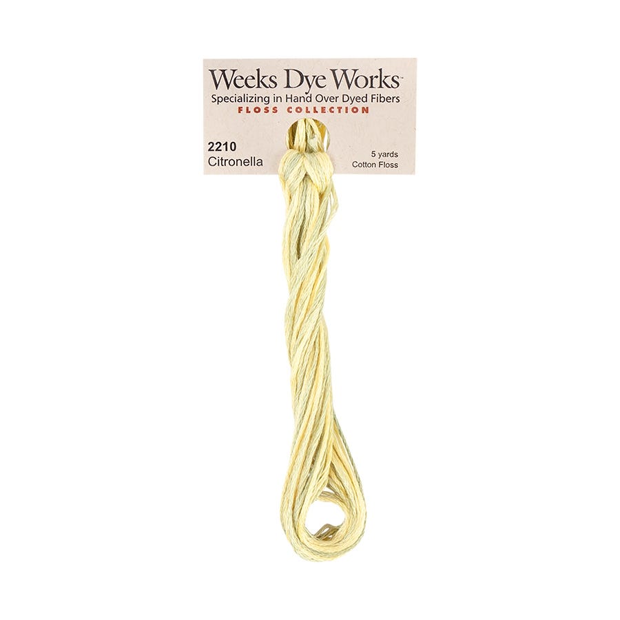 A skein of Weeks Dye Works Citronella cotton embroidery thread in a pale yellow-gold shade, hanging from its original paper label card against a plain white background.
