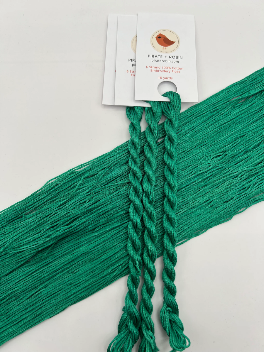Green embroidery floss with a Pirate & Robin label on a white background