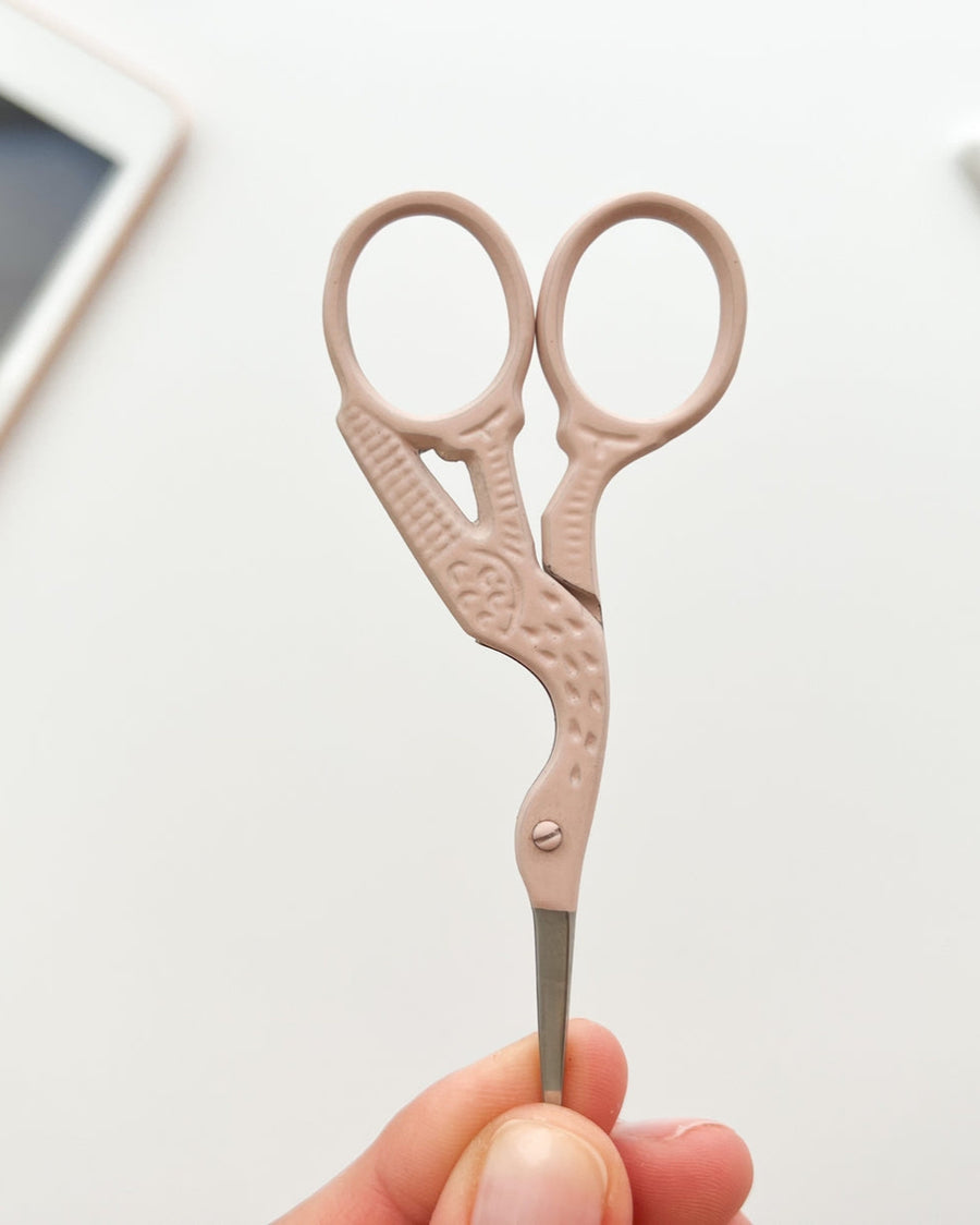 closeup of blush shell stork embroidery scissors