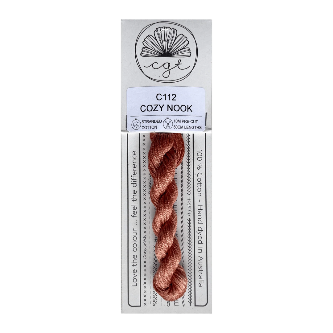 Packaged thread with a label indicating 'Cozy Nook' on a white background