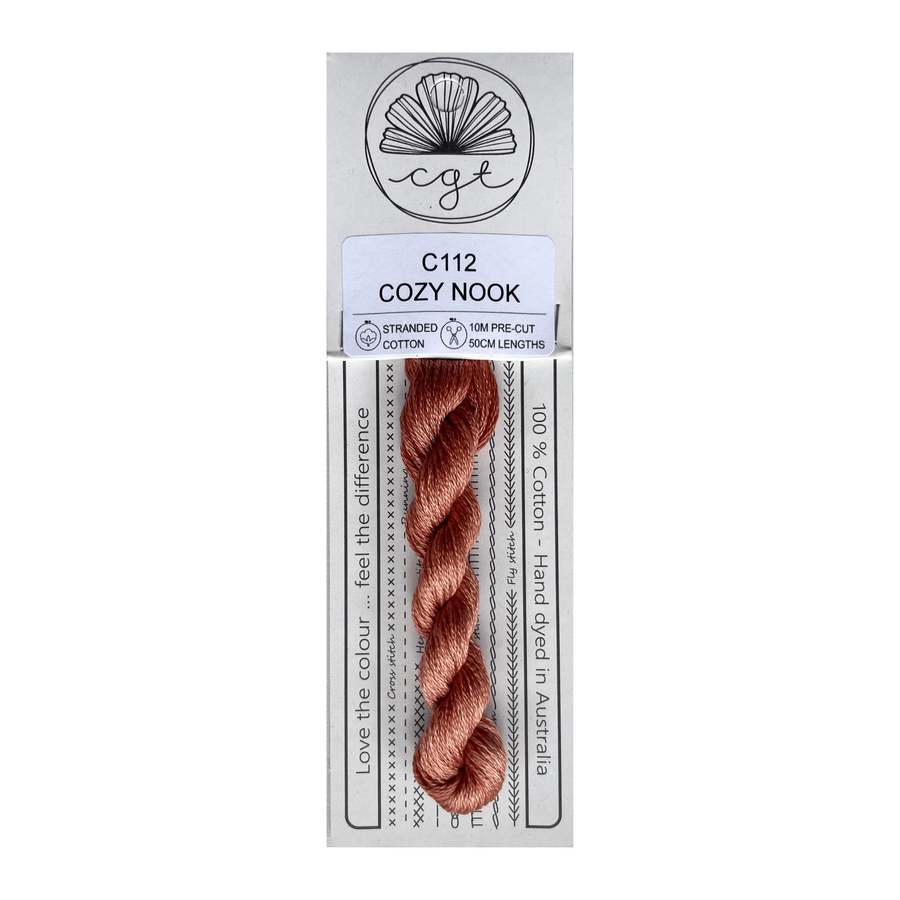 Packaged thread with a label indicating 'Cozy Nook' on a white background
