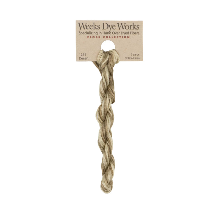 A single twisted bundle of Weeks Dye Works cotton floss in the shade 'Desert', attached to its original kraft paper packaging card against a plain white background.