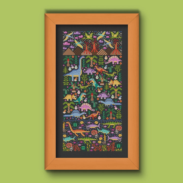 Cross stitch pattern depicting a prehistoric landscape with various dinosaurs and vegetation, contained within a wooden frame.
