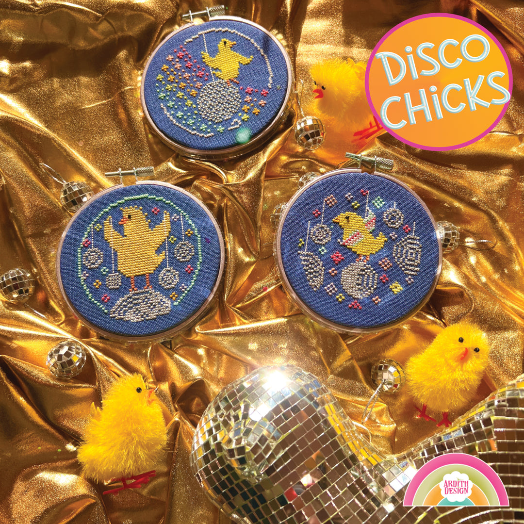 A set of three cross-stitch ornaments featuring stylized baby chicks on disco balls, displayed on a golden background with small yellow plush chicks and a sign reading 'Disco Chicks'.