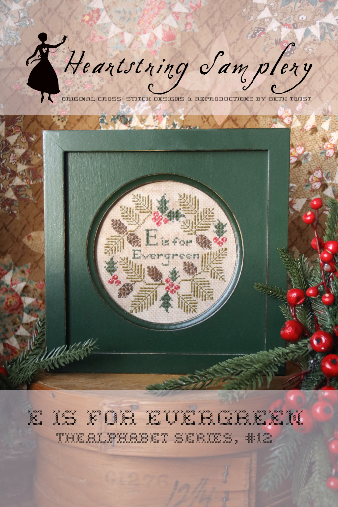Heartstring Samplery cross-stitch pattern with 'E is for Evergreen' design on a textured background.