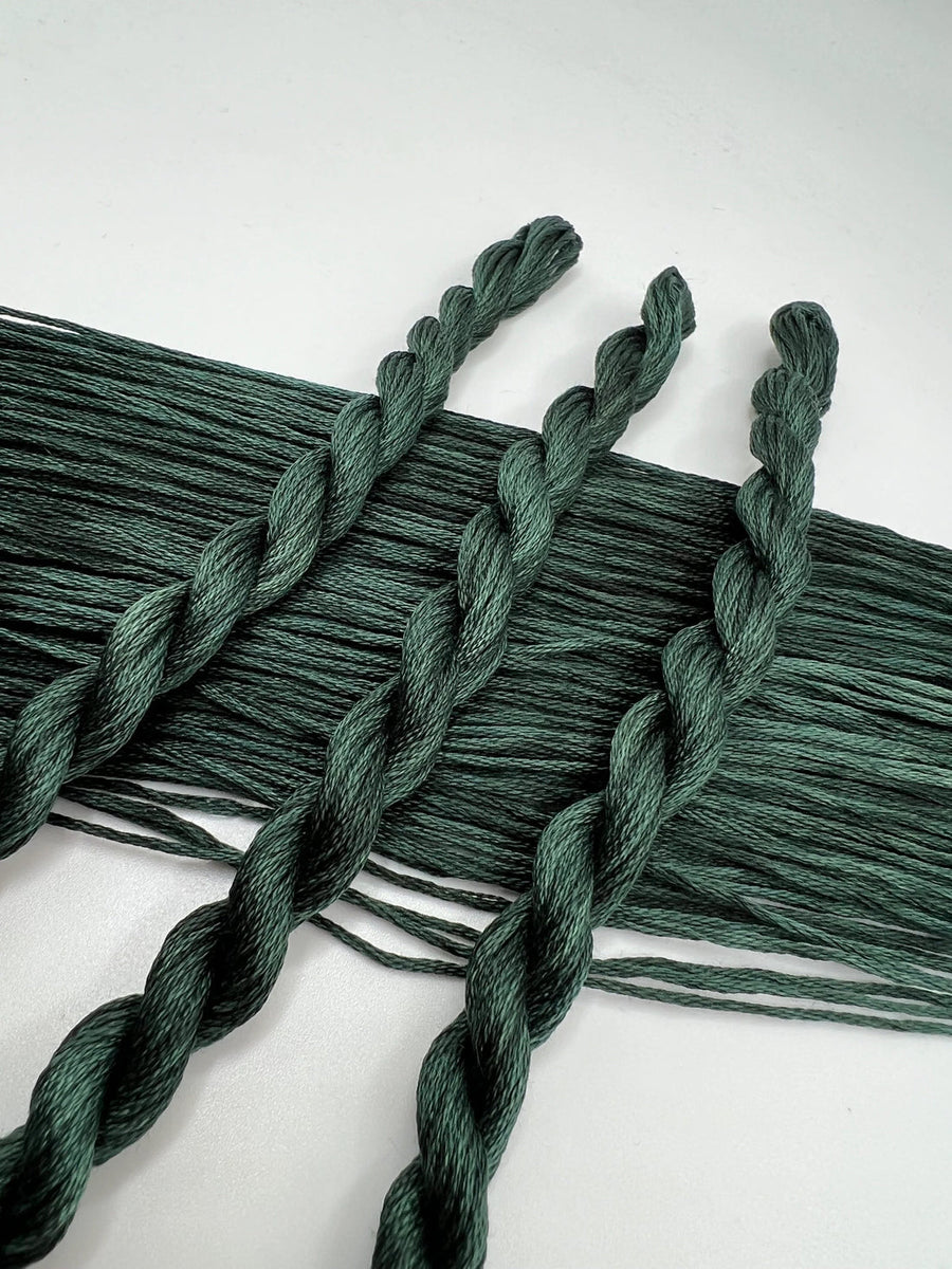 Green braided yarn on a white background