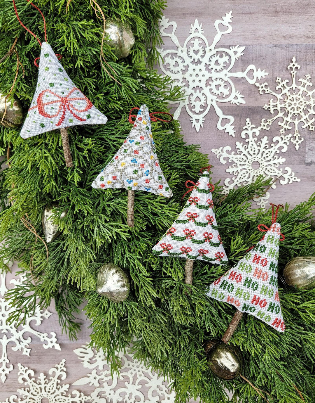 Decorative Christmas tree ornaments on a green wreath with snowflake decorations.